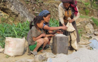 Village women measuring the sand they brought © Copyright Rapcha - Yadav